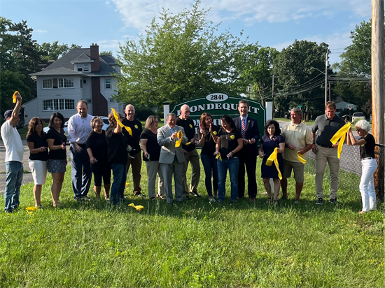 Rep. Morelle and other local leaders celebrate the ribbon cutting of the Irondequoit Community Cupboard's new facility