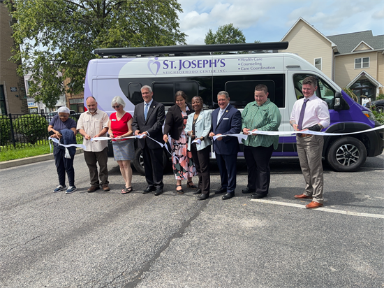 Rep Morelle cuts the ribbon on the new mobile outreach vehicle.