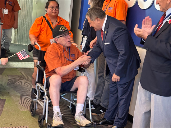 Congressman Morelle shakes hands with honor flight attendees.