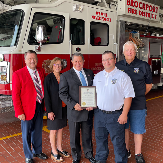 Rep. Morelle stands with Brockport Fire District's Chief Jose Medina and others