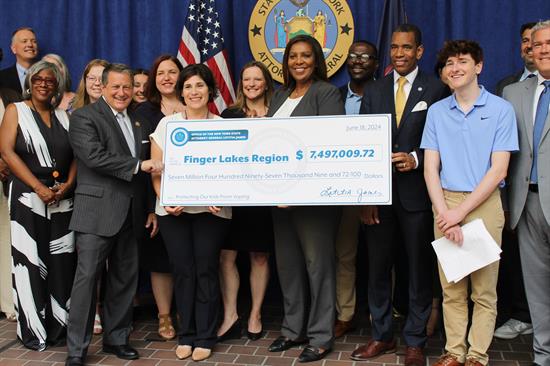 Congressman Morelle stands with local elected officials to receive a check from the NYS Attorney General's office.