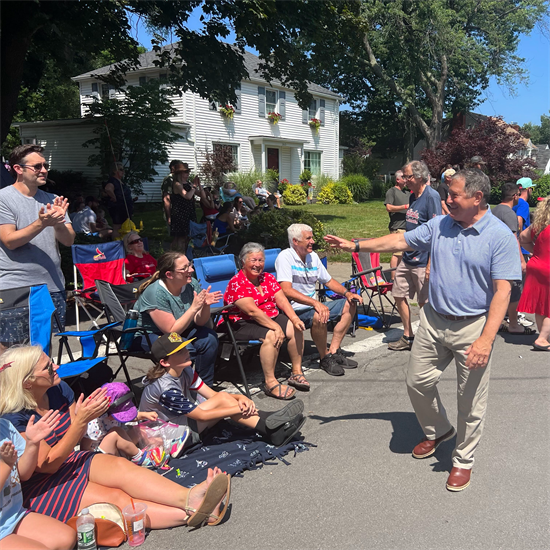 Rep. Morelle waves at community members during a Fourth of July event