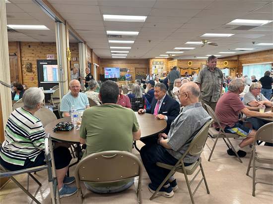 Rep. Morelle sits at a table with a group of seniors