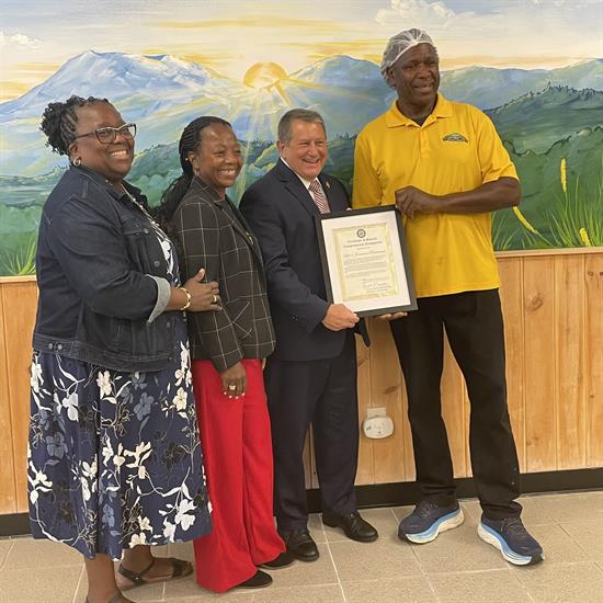 Congressman Morelle presents certificate to Livie's Jamaican Restaurant.