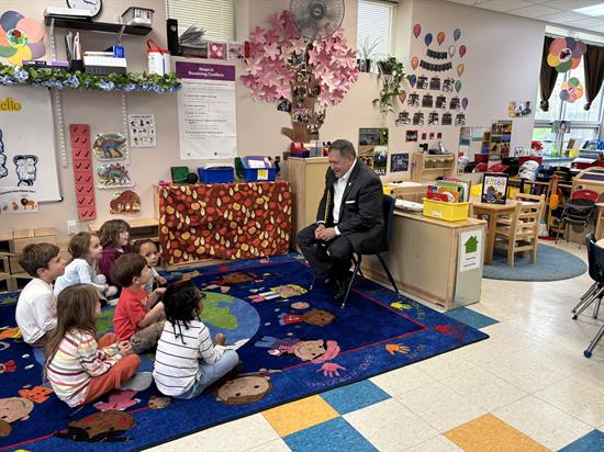Rochester Childfirst visit with Rep. Morelle reading to children in a classroom