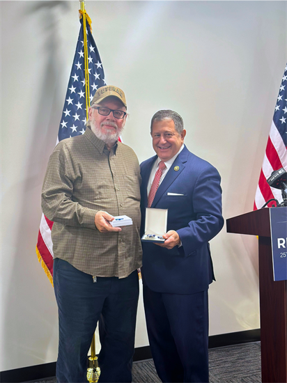 Congressman Morelle stands with medal recipient at a ceremony