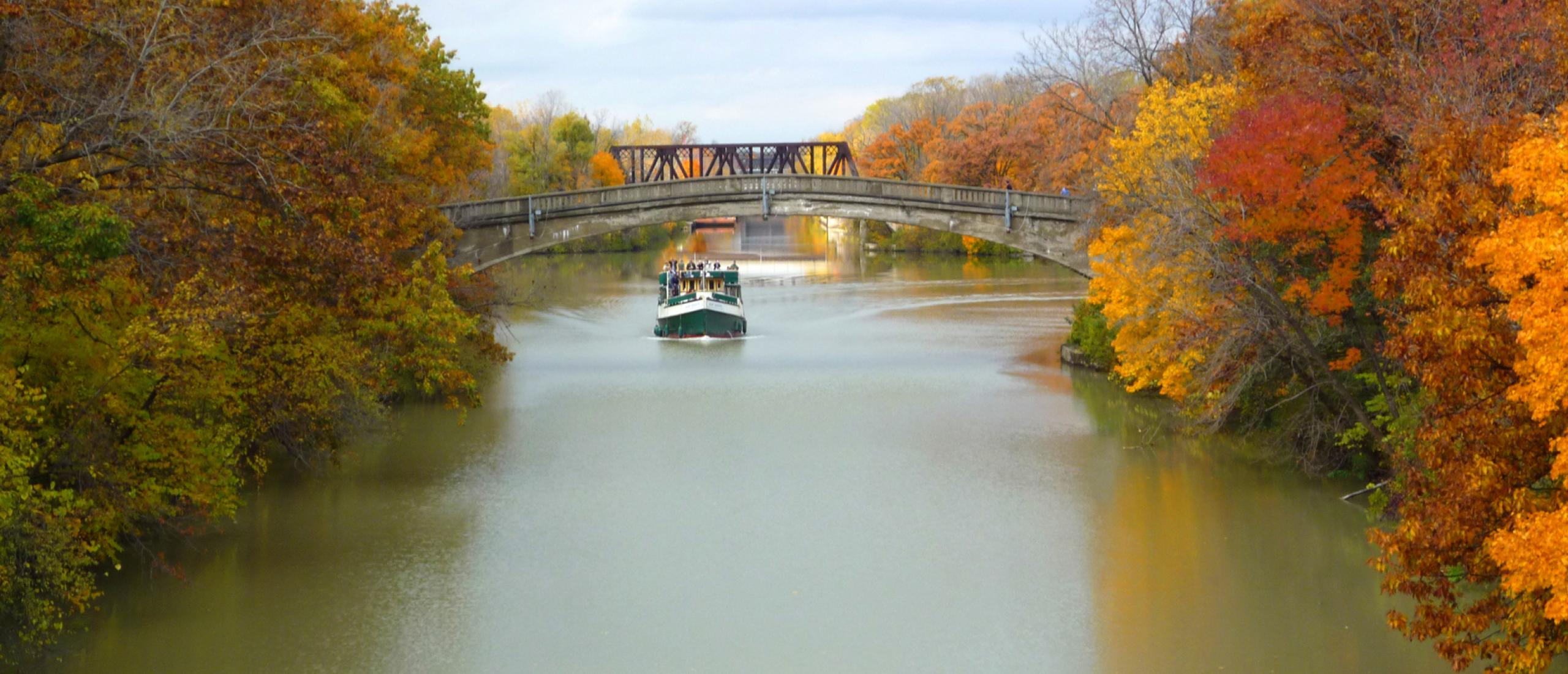 Boat riding down river in New York